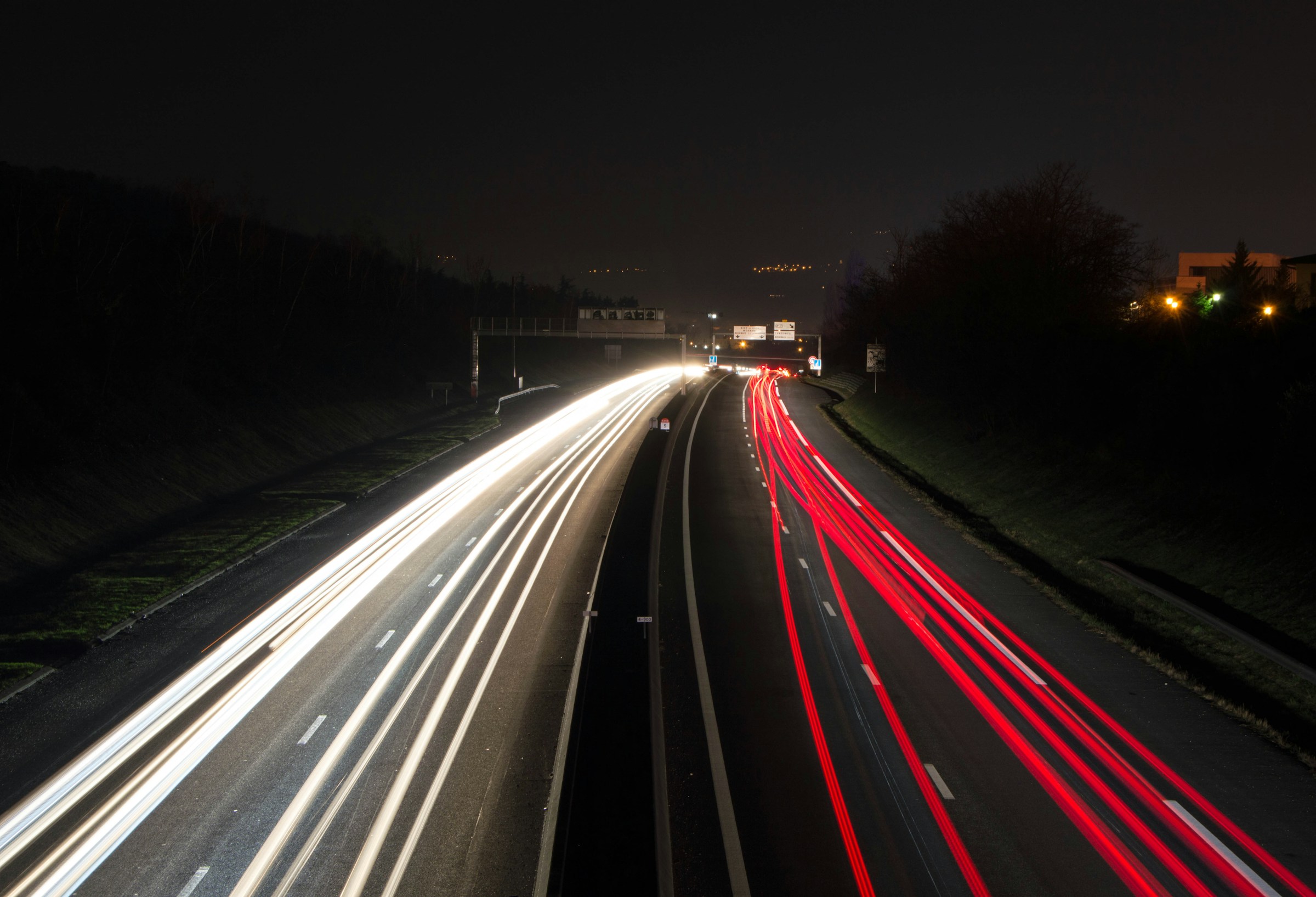 Long exposure of a multi-lane highway at night with light trails